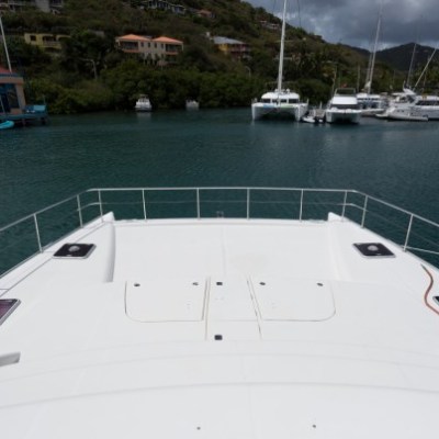 a boat is docked next to a body of water with Ice hockey rink in the background