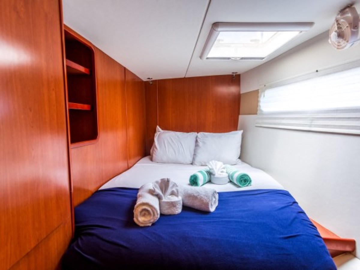 a bedroom with a bed and desk in a room